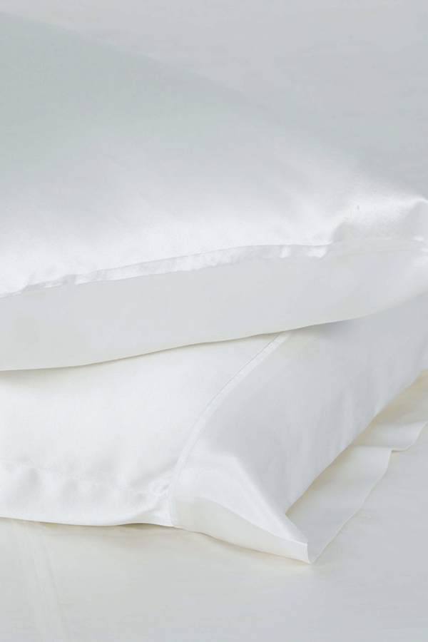 Elegant white silk pillowcases set from The 22 Collection, showcasing smooth texture.