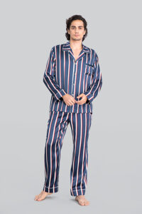 Man wearing Geom Men's Striped Silk Pajama Set, featuring Navy Blue, Crimson Red, and Crisp White Stripes, with a comfortable fit.