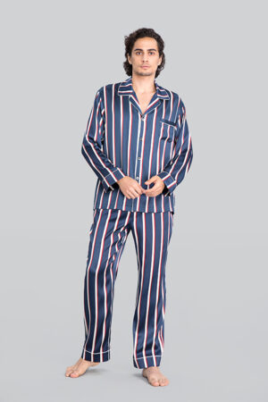 Man wearing Geom Men's Striped Silk Pajama Set, featuring Navy Blue, Crimson Red, and Crisp White Stripes, with a comfortable fit.