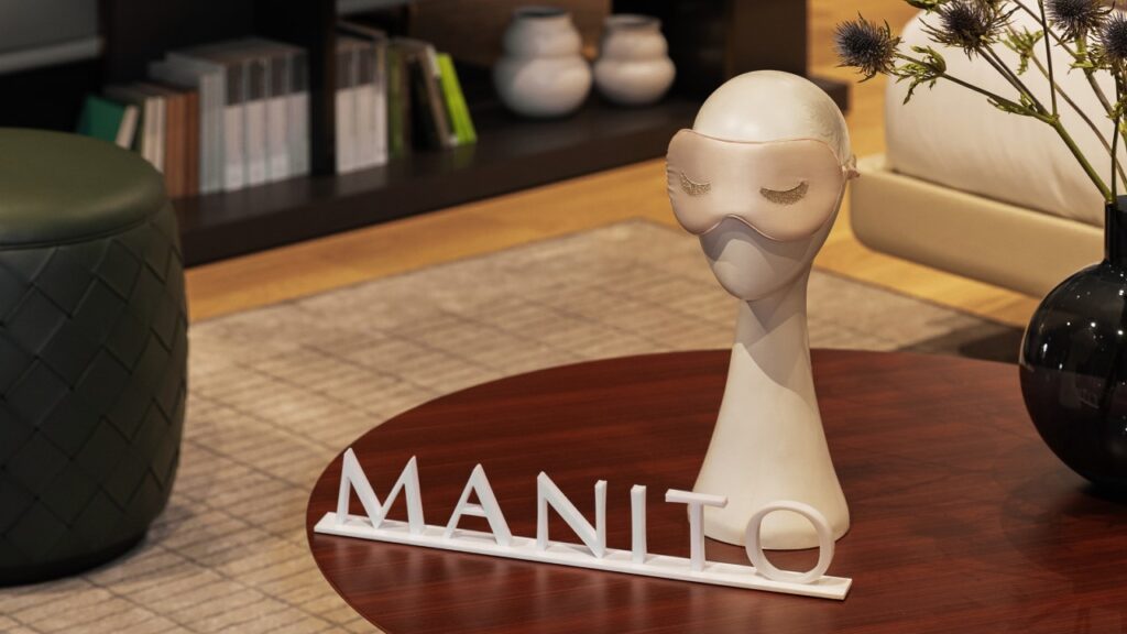 A stylized mannequin head with MANITO silk eye mask, symbolizing luxurious self-care and tranquility.