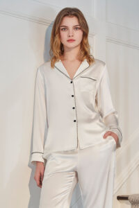 Front view of ivory MANITO Treasure Silk Pajama Set with black piping and button details.