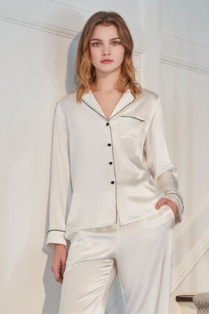 Front view of ivory MANITO Treasure Silk Pajama Set with black piping and button details.