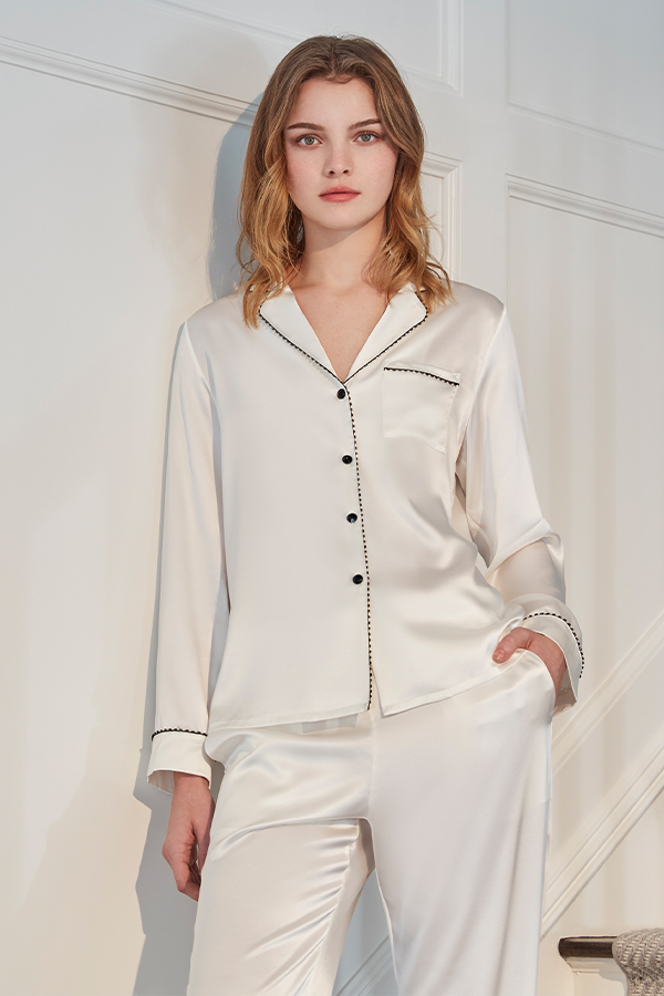 Front view of ivory MANITO Treasure Silk Pajama Set with black piping and button details.