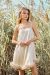 Woman in Diva Feather Trimmed Short Slip Dress, standing in a natural setting, exuding luxury.