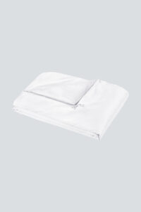 Classic white Silk Throw Blanket folded flat with smooth satin texture.