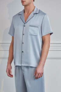 Elegant man wearing Men's Short Sleeve Silk Pajama Set with button-up shirt and matching pants.