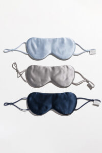 Three Cozy Silk Eye Masks in blue, gray, and navy, made with Soft Light® mulberry silk fabric.
