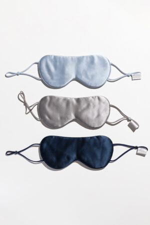 Three Cozy Silk Eye Masks in blue, gray, and navy, made with Soft Light® mulberry silk fabric.