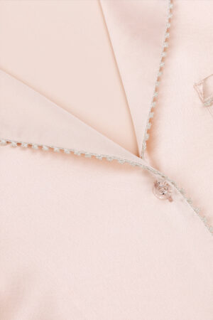 Close-up detail of MANITO Treasure Silk Pajama Set collar with delicate trim and silk button.