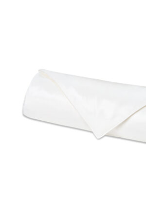 Gleam Silk Quilt folded into a low, rounded roll, white silk surface smooth and lightly lustrous.
